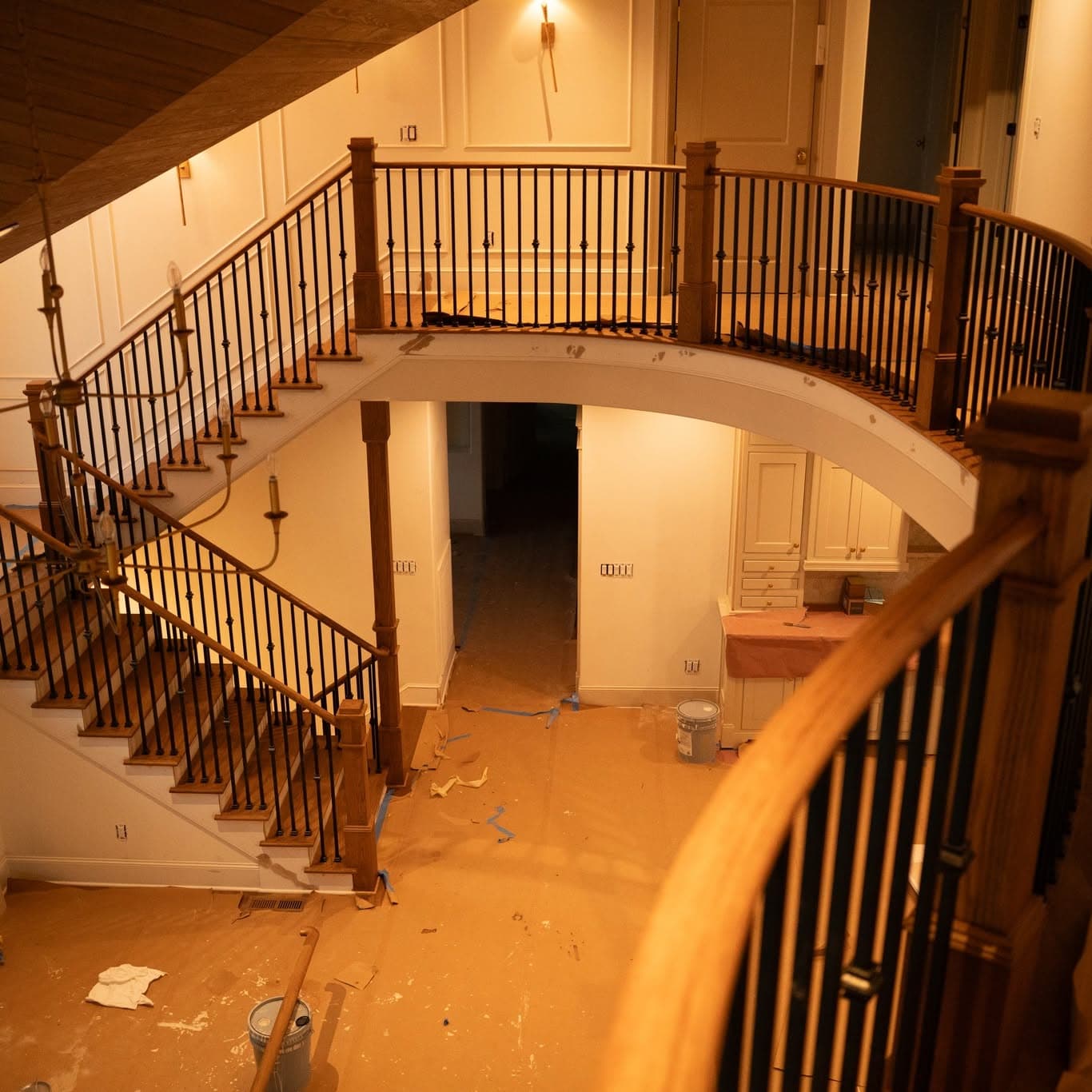 Curved balcony stair railing overlooking two-story foyer