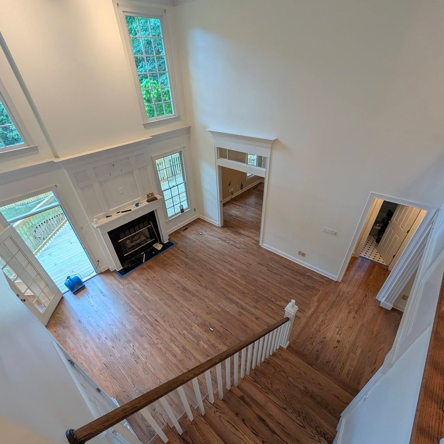 High-angle living-room view with stair railing along the bottom of the frame