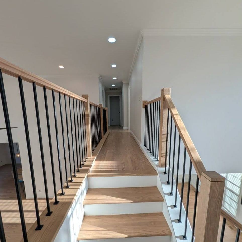 High-angle view of a short wood stair/landing with wooden railings