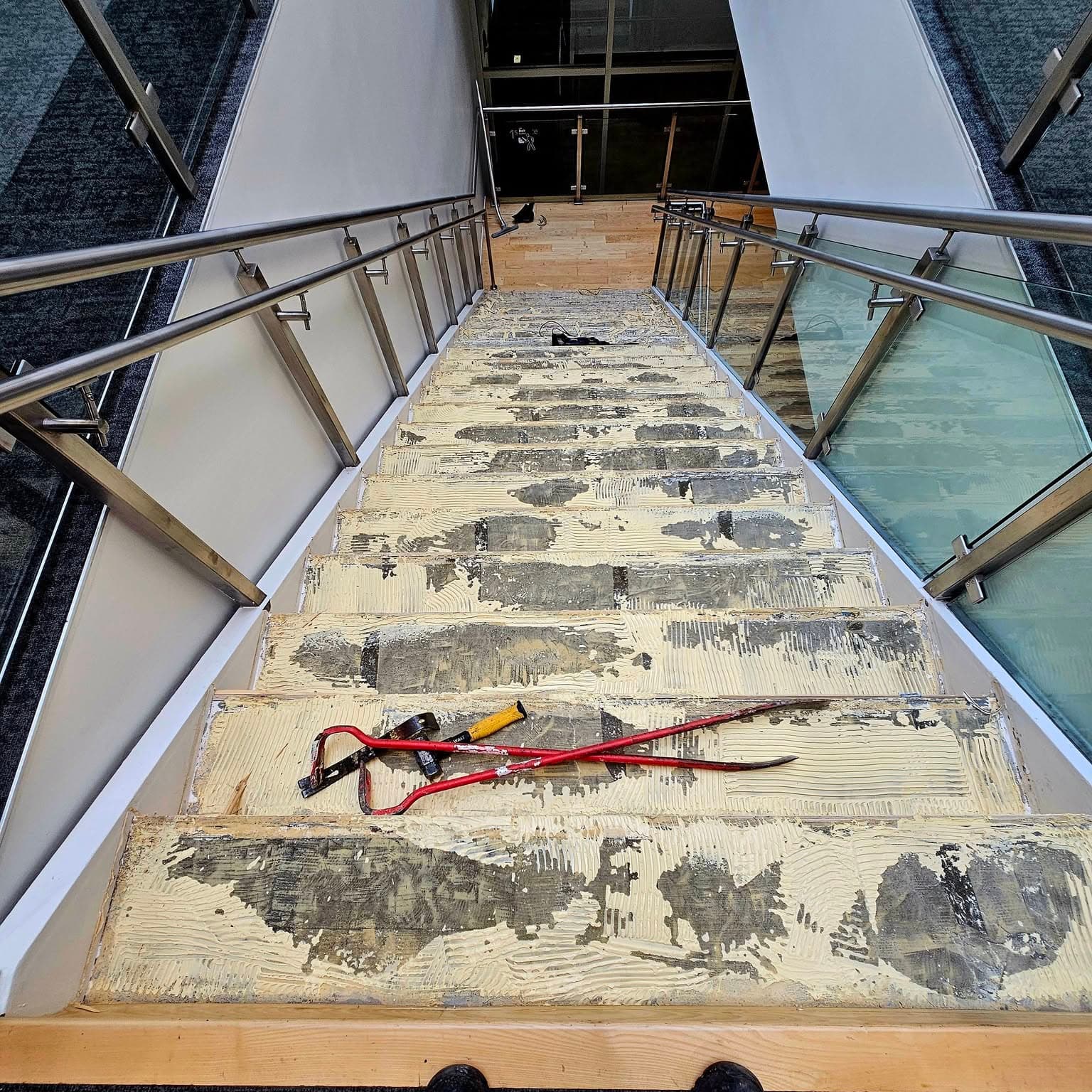 Overhead view of a decorative rug on a landing between stair sections