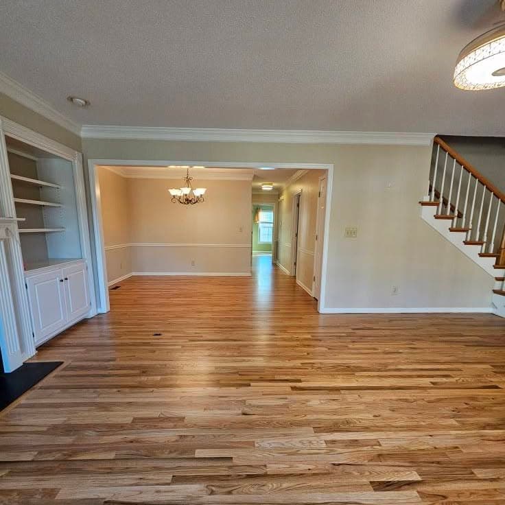 Wide interior; traditional stair with wood treads and white risers at right