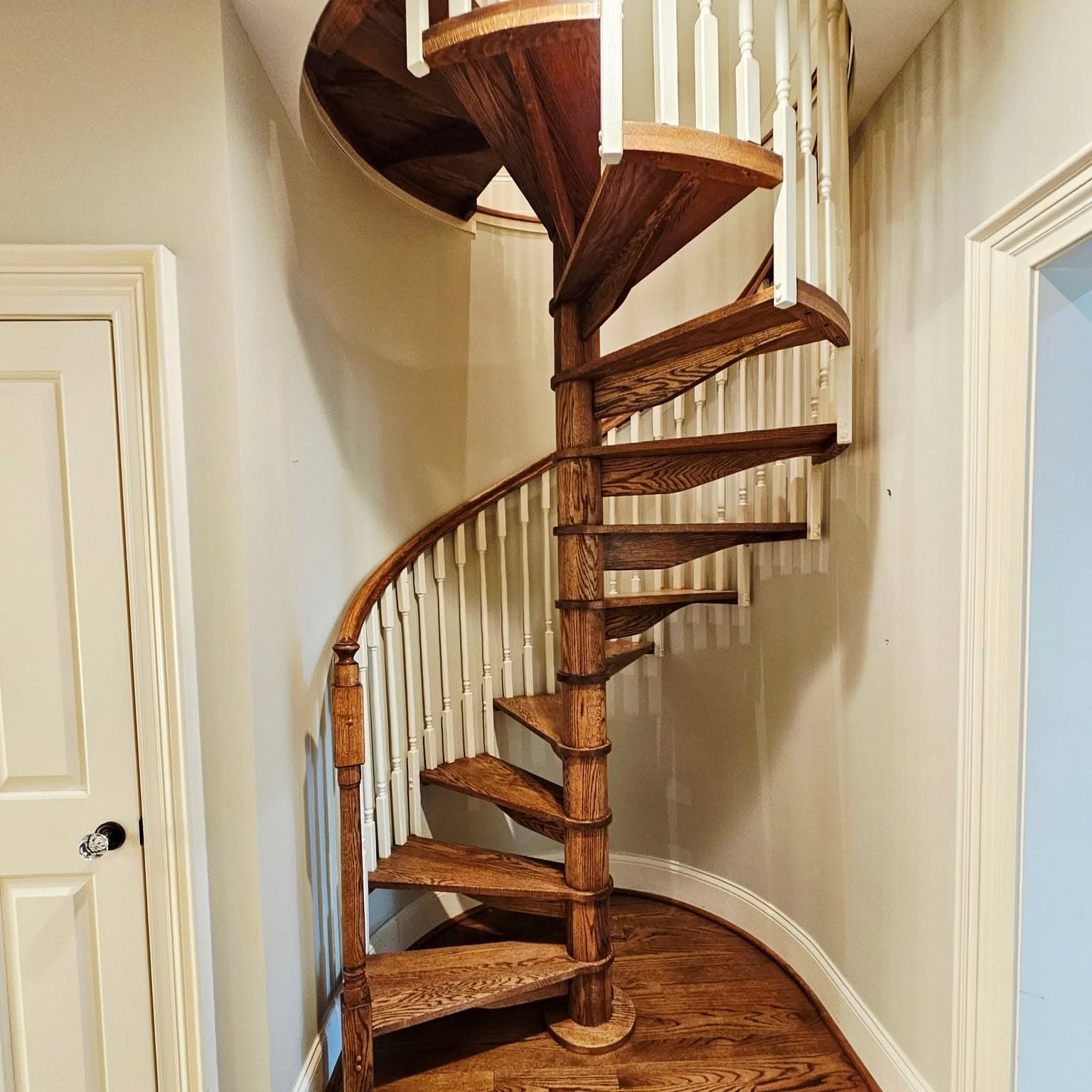 Wooden spiral staircase in a small curved nook