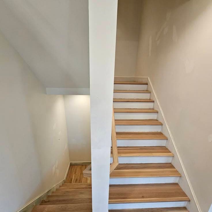 Looking up a wooden stair flight from the bottom