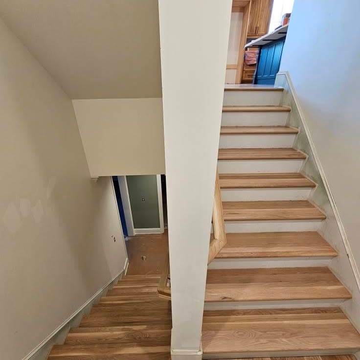 Another view looking up the same wooden stair from the bottom