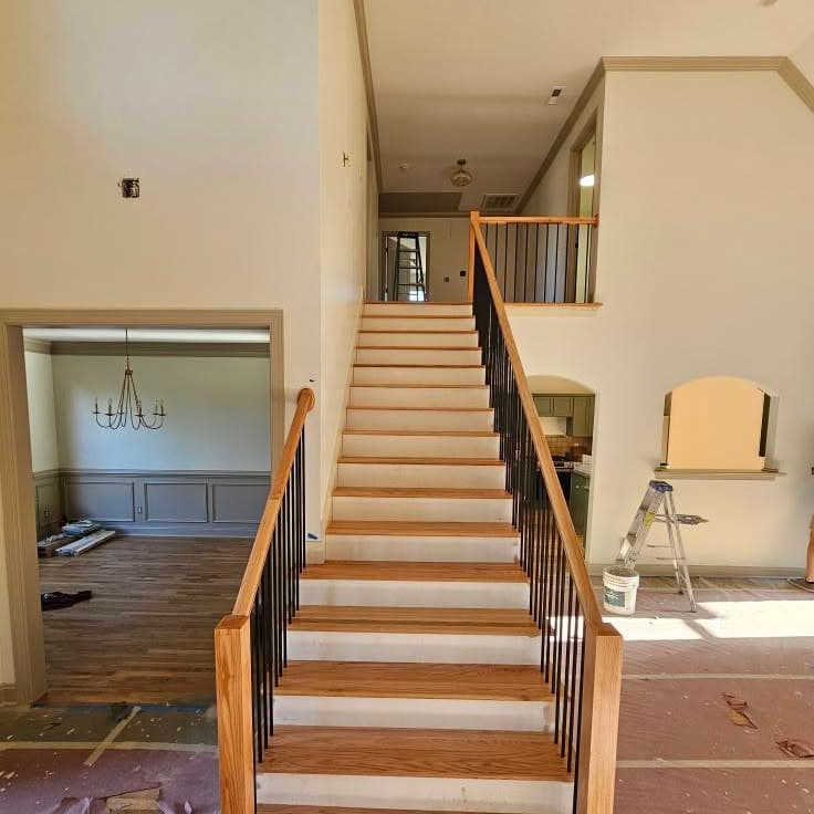 Straight-on view of wooden stairs rising between walls