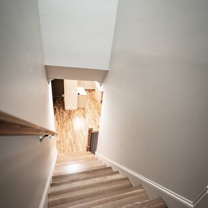 High-angle look down a light-colored wooden stair