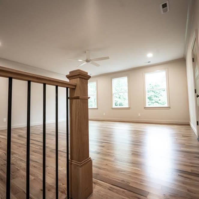 Landing with a prominent wooden newel post and balusters overlooking below