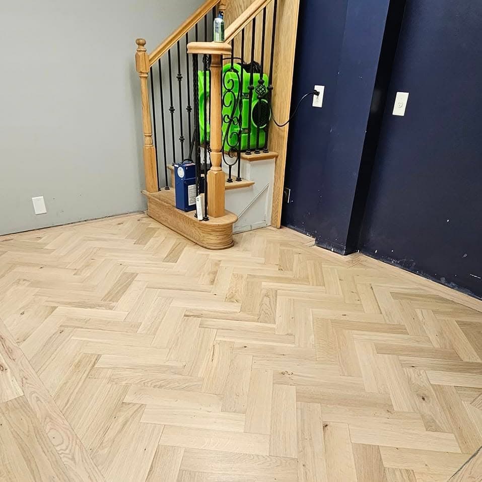Partial stair at left: light wood treads, white risers, white spindles, wood newel