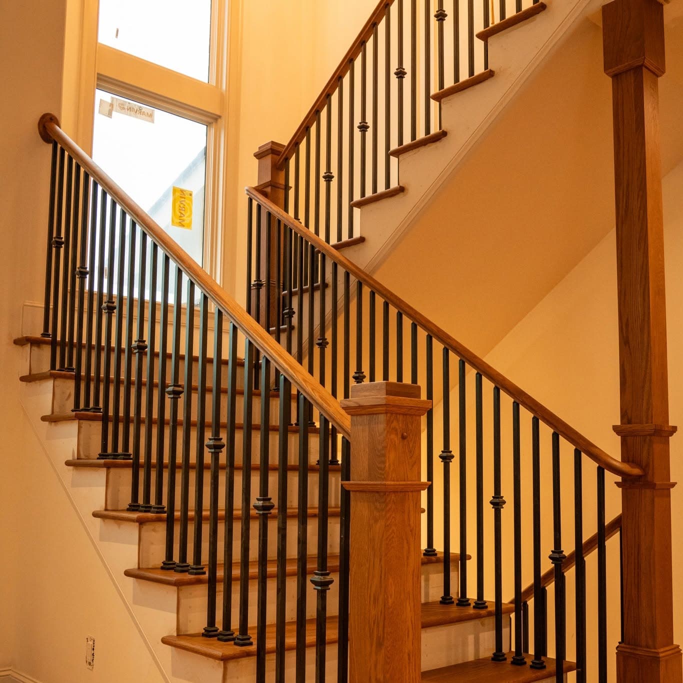 Full interior stair run with square wood newels and black metal balusters, Rocket City Stairs